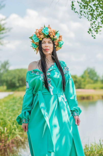 Ukrainian fashionable woman in embroidery traditional dress. Concept of brave Ukraine and people of that country. Ethno clothes style for ladies, Boho mix fashionable details. Slavic brunette lady - Photo, Image