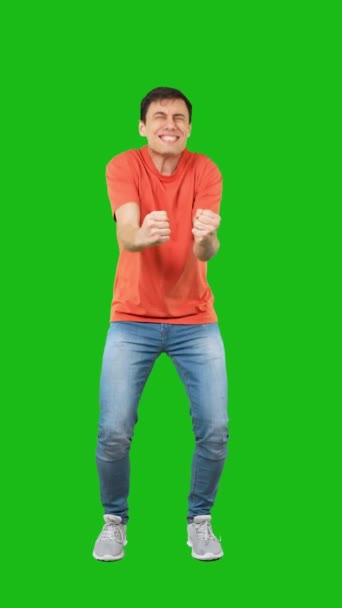 Full body man in casual clothes celebrating victory against green background - Кадры, видео
