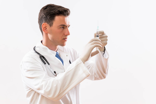 Image of young  doctor with injection. - Foto, Bild