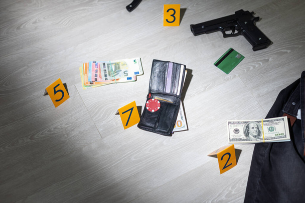 Flat lay composition with evidences and crime scene markers on wooden background. High quality photo - Photo, Image