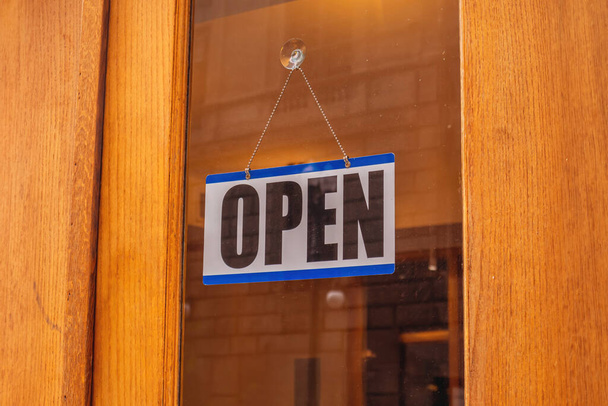 Open text sign on a glass entrance door, close up  - Zdjęcie, obraz