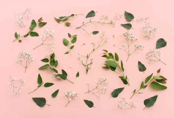 Top view image of flowers composition over pink pastel background - Foto, imagen