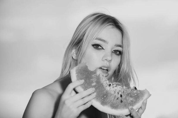 Young girl eating watermelon, summer tropical fruits. Beauty woman face - Fotó, kép