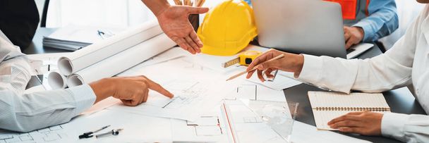 Engineer partner drawing and working on blueprint design together on office table for architectural building construction project. Architect drafting interior blueprint layout. Insight - Photo, Image