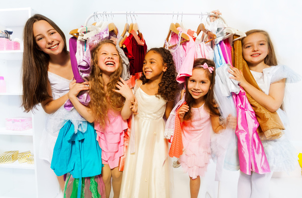 Happy girls among clothes - Zdjęcie, obraz