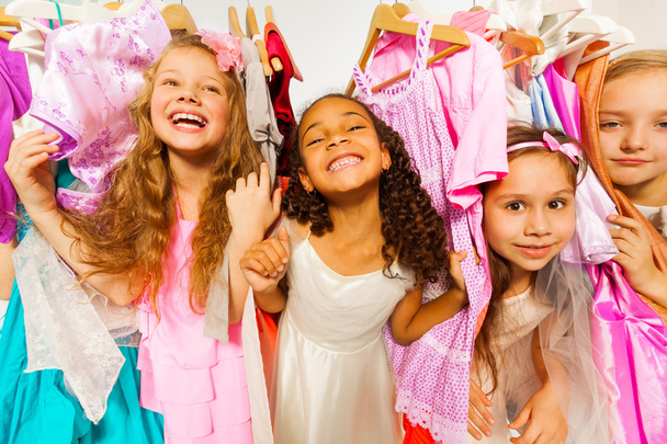 Laughing girls among dresses - Zdjęcie, obraz
