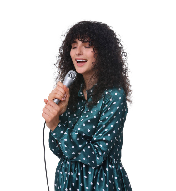Beautiful young woman with microphone singing on white background - Fotoğraf, Görsel