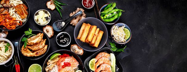 Various  asian meals dishes on black background , top view. Asian food concept. Copy space. Banner - Fotó, kép