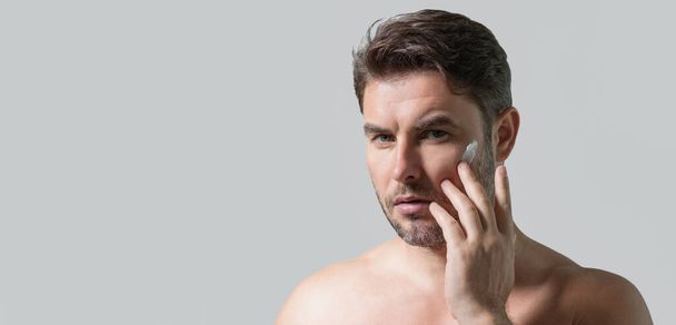 Cosmetic cream for man. Spa male model, skincare product for skin face. Morning mask for skin with anti-aging effect. Skin care. Male face cream. Man with perfect soft skin. Beauty cosmetic banner - 写真・画像