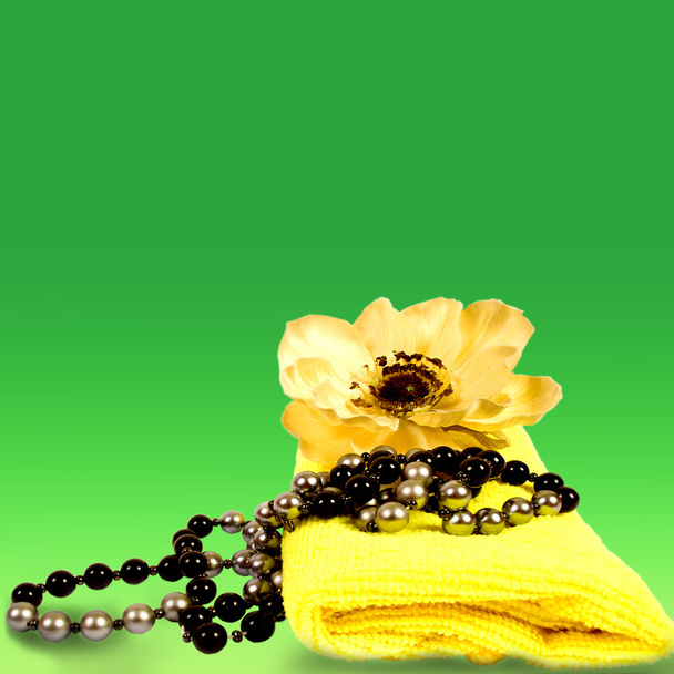 Towel with beads and a flower in the background, mother's day - Photo, Image