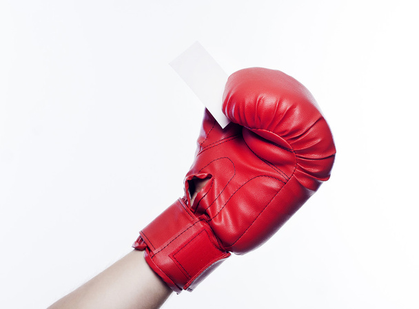 Hand in boxing gloves holding business card - Foto, Imagen