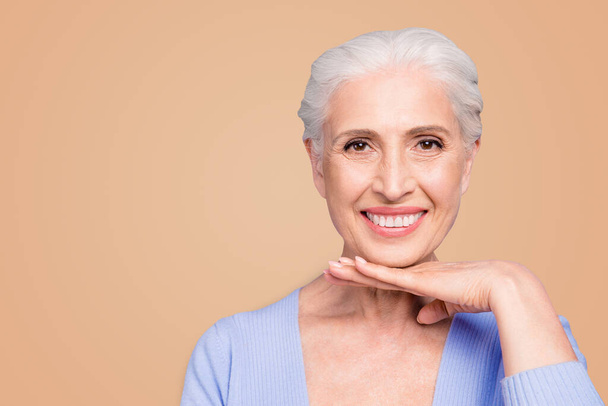 Portrait of gray haired beautiful smiling old lady showing her shining smile with white healthy teeth, copy space, isolated over violet background. - Photo, Image