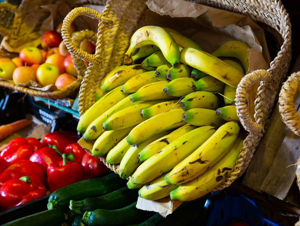 close up of mature bananas on counter in marketplace - Fotó, kép