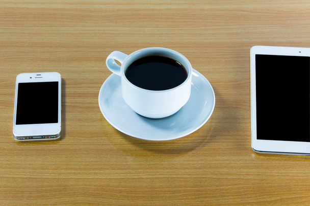 Computador tablet digital com xícara de café na mesa de madeira velha
.  - Foto, Imagem