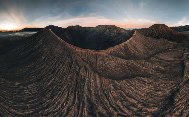 Aerial drone view of Bromo crater Mountain, East Java, Indonesia. man standing on the edge of Bromo crater, high contrast, Bromo Tengger Semeru National Park. - Photo, Image