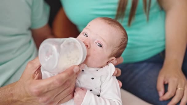 Caucasian baby girl drinking milk from feeding bottle - Footage, Video