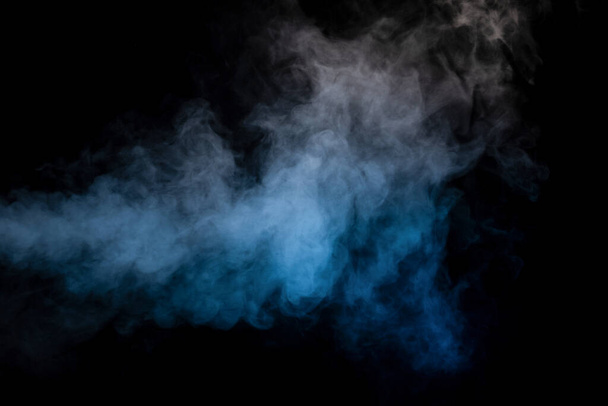 Blue and yellow steam on a black background. Copy space. - 写真・画像