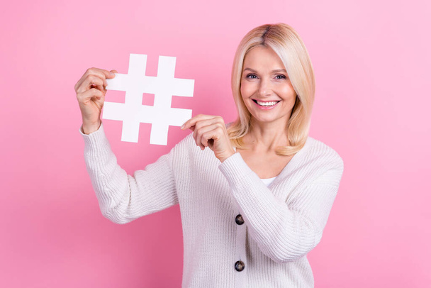 Photo of satisfied adorable cheerful woman with bob hairstyle knit cardigan hands demonstrating hashtag isolated on pink color background. - Foto, Bild