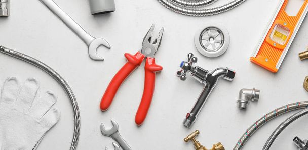 Set of plumber's supplies on light background - Photo, Image