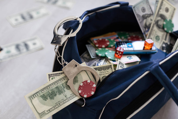 Black duffel bag full of dollar notes in criminal investigation unit, conceptual image. High quality photo - Zdjęcie, obraz