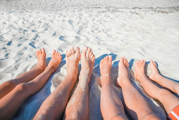 feet of a happy family near the seashore in nature weekend travel - Photo, image