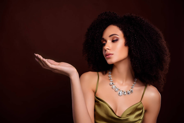 Photo of attractive dream lady jewel shop assistant present luxurious pendants on dark brown color background. - Foto, imagen
