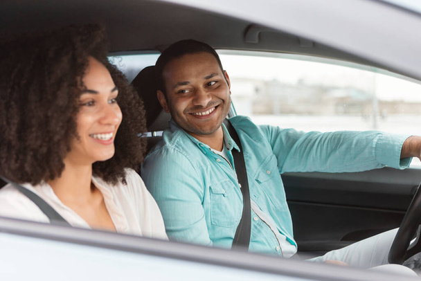 Owning A Car. Happy Middle Eastern Couple Driving Enjoying Journey By Vehicle, Man Driver Smiling To His Wife Traveling By New Automobile Sitting Inside. Rent And Leasing Offer. Selective Focus - Foto, Imagen