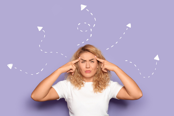 Portrait of troubled young woman on lilac background - Photo, Image
