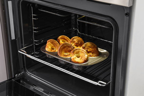 Baking tin with tasty Yorkshire pudding in oven - Фото, зображення