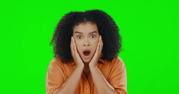 Face, wow and portrait of woman on a green screen with hands on face. Young female model on a studio background with bad news, gossip or shocked emoji expression to secret, surprise and mockup space. - Felvétel, videó