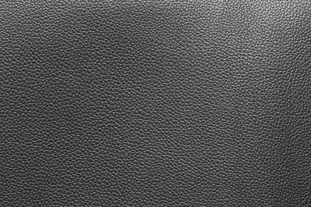 Black leather and a textured background. - Photo, Image