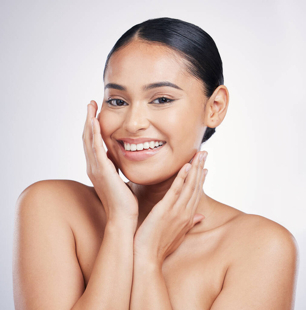 Natural, beauty and woman with hands on face in studio for glow, dermatology or cosmetics. Portrait of a happy aesthetic model person with self care, facial or skincare results on a white background. - Photo, Image