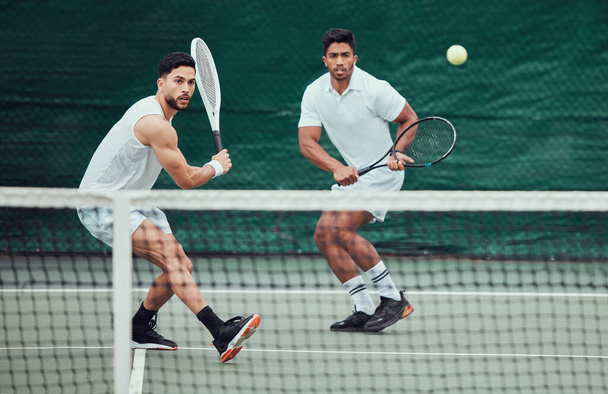 Male team, ball and tennis court during a competition in india for fitness, health and sport. Man, athlete and together with action for game with training and a challenge for wellness in the outdoor - Foto, afbeelding