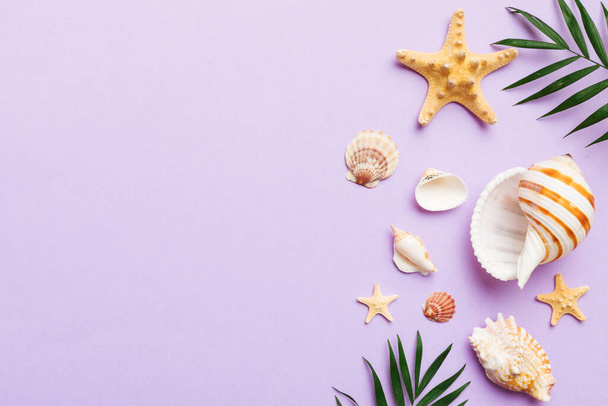 Summer time concept Flat lay composition with beautiful starfish and sea shells on colored table, top view with copy space for text. - Photo, image