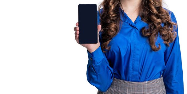 cropped view of teen girl showing phone app on background. photo of teen girl showing phone app at screen. teen girl showing phone app isolated on white. teen girl showing phone app in studio. - Photo, image