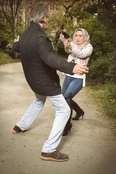 Secret police agent capturing deviant attacker in city park - Fotó, kép
