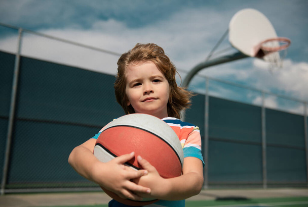 Kid playing basketball. Child boy preparing for basketball shooting. Active lifestyle. Basketball kids school - Foto, Imagem