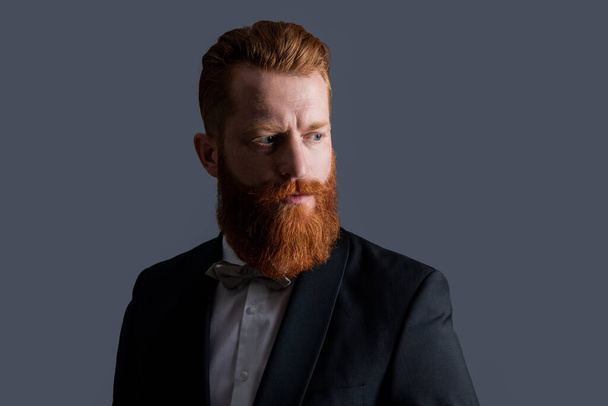 face of bearded man in tux formalwear isolated on grey background. man studio shot in tux formalwear. man wearing tux formalwear. tux formalwear. - Fotó, kép