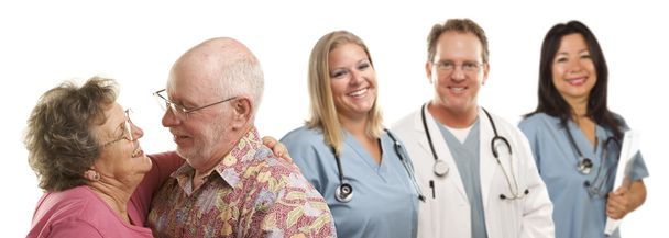 Senior Couple with Medical Doctors or Nurses Behind - Photo, image