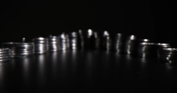 Стеки серебряных монет на черном фоне. Уклонение от уплаты налогов и доходов - Кадры, видео