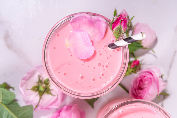 Rose flower milkshake, asian Moon milk drink. Pink matcha cocktail with rose petals. - Foto, imagen