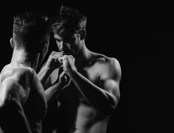 Handsome guys fighting. Two young men standing face to face. Naked body, nude bare torso - Fotó, kép