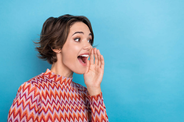 Photo of excited adorable lady wear striped top arm mouth screaming empty space isolated blue color background. - Photo, image