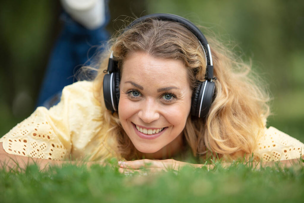 beautiful young woman with headphones outdoors - Фото, изображение