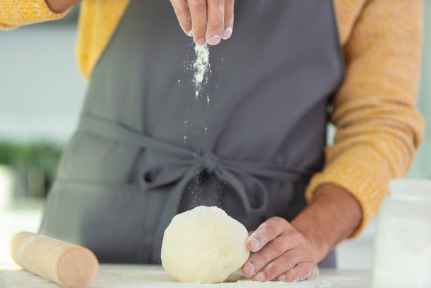 woman kneading dough close-up photo - 写真・画像