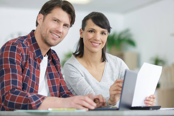 happy couple reading mail and checking accountancy - Foto, imagen