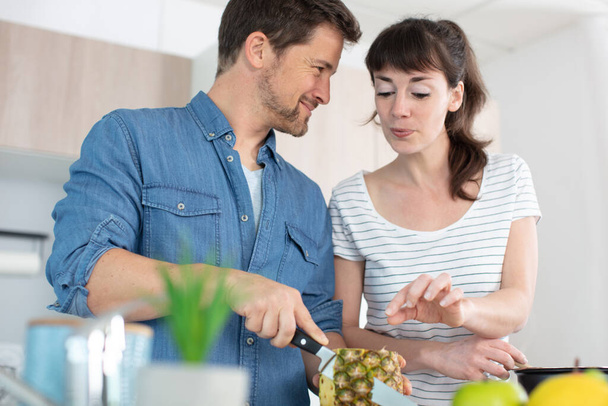 young couple making smoothie in kitchen - Foto, imagen