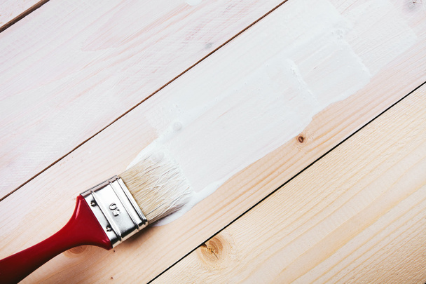 paint brush painting on wooden surface - Foto, Imagem