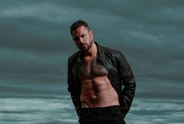 Portrait of handsome man with serious face. Fashion male model with leather jacket - Photo, Image