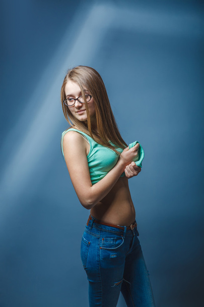 European-looking girl of twenty years in glasses bared stomach o - Photo, image